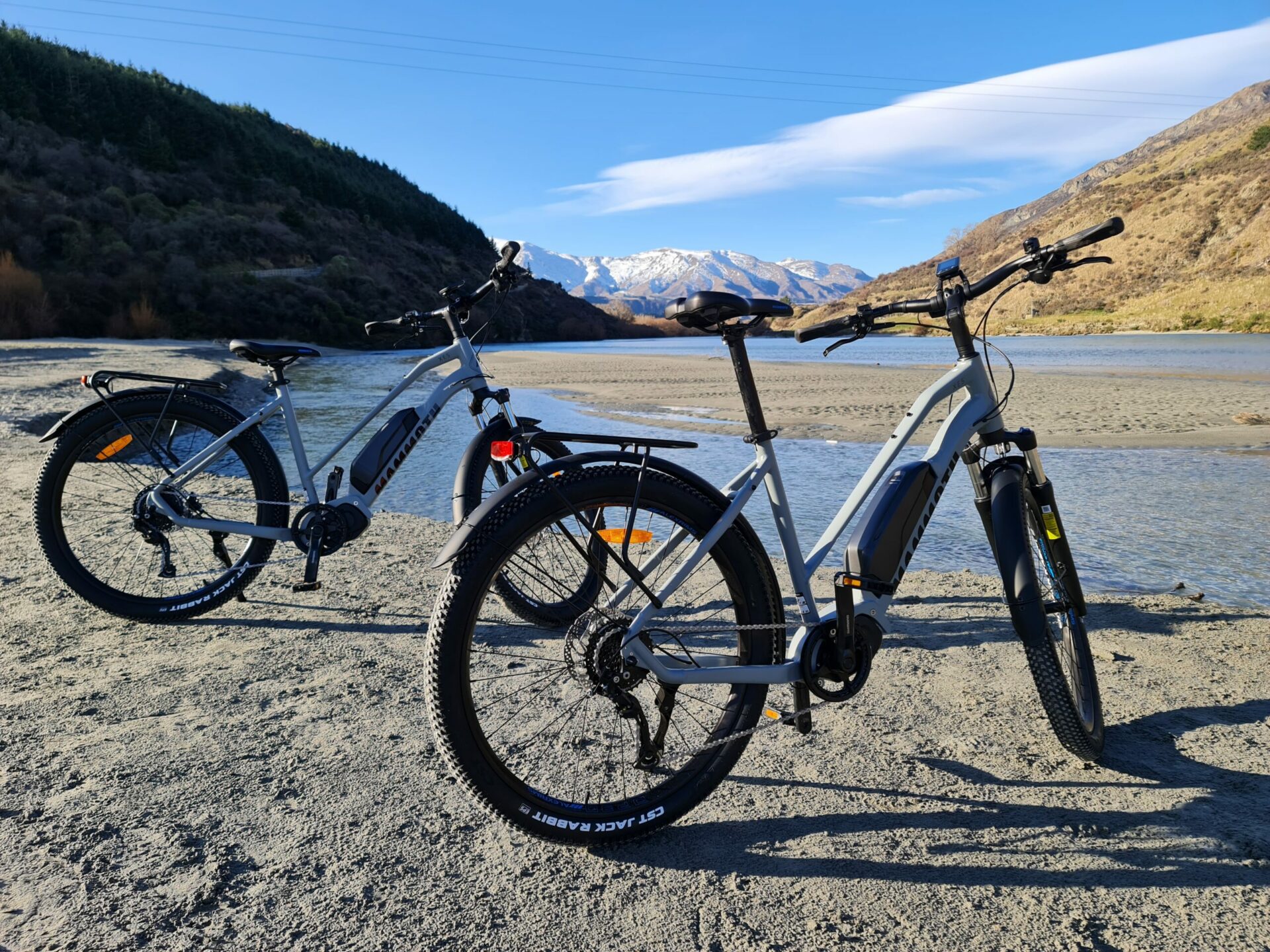 hire E bikes standing against river background